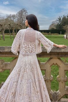 This jacket lehenga set features embroidery in white and silver sequin and crystal on a nude base. The strappy blouse is fully embroidered and shows tassels at the waist. The ensemble is paired with a matching flowy jacket.From Seema Gujral's A Royal Affair collection. DELIVERY TIMEPlease allow 8-12 weeks for your outfit to arrive. FABRIC DETAILSNet Professional cleaning only. Bohemian Embellished Wedding Sets, Bohemian Embellished Lehenga For Weddings, Bohemian Embellished Wedding Lehenga, Bohemian Sequin Sets For Reception, Bohemian Style Hand Embellished Wedding Sets, Bohemian Wedding Sets Hand Embellished, Bohemian Hand Embellished Wedding Set, Bohemian Embellished Choli For Wedding, Elegant Embellished Spring Lehenga