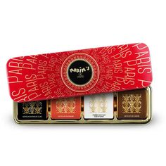 four different types of chocolates in a red and gold tin with the words happy new year on it