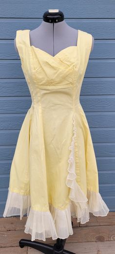 1950s handmade yellow a-line dress with ruffle down the front and on the skirt bottom. It has a shelf bra and metal zipper.  No size and no company Measurements Length 40.5 inches chest 36 inches waist  26 inches Yellow Dresses With Ruffles And Fitted Bodice, Yellow Fitted Dress In 1950s Style, Fitted Yellow Dress In 1950s Style, Yellow Vintage Dress 1950s Style For Spring, Yellow Vintage Dress, 1950s Style For Spring, 1950s Style Vintage Yellow Dress For Spring, Yellow 1950s Style Dress For Vintage Fashion, Yellow Fitted Vintage Dress 1950s Style, 1950s Style Yellow Dress For Vintage Fashion