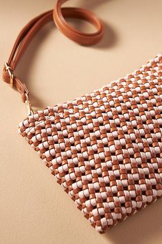 Polyurethane; polyester lining Convertible silhouette can be worn as a crossbody or clutch Removable and adjustable strap One inner zip pocket Zipper closure Imported | The Kalani Woven Knot Clutch: Faux Leather Edition by Anthropologie in Pink, Women's, Polyester/Polyurethane On-the-go Crossbody Clutch With Detachable Strap, Versatile Crossbody Clutch, Summer Crossbody Clutch With Detachable Strap, Summer Brown Crossbody Clutch, Faux Leather Clutch For Travel, Brown Crossbody Clutch For Summer, Faux Leather Travel Clutch, Spring Brown Woven Leather Shoulder Bag, Summer Clutch With Adjustable Strap