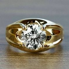 a gold ring with a diamond in the center