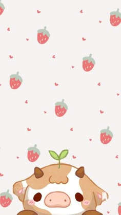 a cartoon cow sitting in front of a wall with strawberries on it