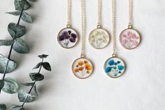 "New design of pressed baby's breath resin necklace. 14K gold plated brass chain and bezel. Pendant diameter: 0.98\"(25mm) Chain options: 14k gold plated brass chain, length: 16\"+2\" extender. 14k gold filled chain, 18 inches. Color: white, blue, purple, orange, pink. Come with handcraft gift box, beautiful gift for your loved one. Free shipping on order over 35( U.S. only)" Brass Jewelry With Birth Flower For Gift, Gold Sterling Silver Necklaces With Pressed Flowers, Gold Sterling Silver Necklace With Pressed Flowers, Nature-inspired Necklace With Adjustable Chain For Gift, Nature-inspired Necklace With Adjustable Chain As Gift, Nature-inspired Jewelry With Adjustable Chain As Gift, Dainty Pressed Flower Necklace For Mother's Day, Flower Charm Necklaces With Pressed Flowers, Pressed Flower Pendant Jewelry For Mother's Day