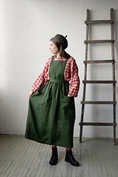 Long cross back pinafore is made from 100% soft and washed linen.  Details: - Colour: Forest green - Composition: 100% Oeko-Tex certified linen - Cross back - Adjustable with buttons - Size: One size - Medium weight linen - Linen care: machine wash gentle; tumble dry low, ironing optional - The price is for one pinafore dress, other pictured items are not included The model is 173 cm/5'8" and wears a size one size. Linen Pinafore, Apron Cooking, Apron For Women, Apron Kitchen, Cooking Apron, Pinafore Dress, Linen Apron, Style Expert, Dining Linens