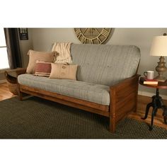 a couch sitting on top of a wooden floor next to a lamp