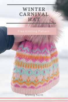 the winter carnival hat is knitted with pink and blue yarn