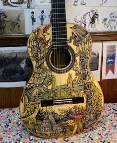 a wooden guitar with pictures on the wall behind it