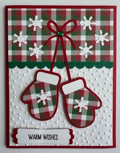 a christmas card with two mittens on it