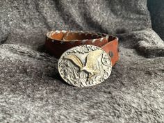 Vintage brown leather embroidered belt/ belt with big metallic buckle with Eagle CONDITION: Very good. No spots on metal, or wearing of leather. MEASUREMENTS: Length max: 30.5 '' ( 94 cm)  Length min: 37'' ( 77 cm)  Width: 1.5'' ( 3.5 cm) SHIPPING * I ship worldwide via Priority mail (Latvijas Pasts) from Latvia (EU). * I ship from Europe, so please allow 2 to 4 weeks for the package to arrive if you live overseas. * Ship to US will take 2 weeks * Europe 5 - 10 business days Gold Embroidered Leather Belt, Vintage Silver Embroidered Belt, Western Silver Embroidered Belt, Embroidered Belt, Le Port, Suspender Belt, Vintage Brown, Suspenders, Brown Leather