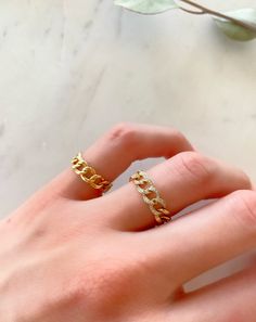 Dress up your everyday basics with this Cuban Chain Ring, expertly crafted in glowing 14K gold with the option of Diamonds. Add a couple of delicate fine rings to this beauty!! Your chain necklaces can now be paired with a sleek matching ring. This modern-luxe link band adds instant sophistication. Metal: 14K Yellow Gold (Stamped) Chain Width: 5 mm Stone: Diamonds Size Option: 6, 6.5, 7, 7.5, 8, 8.5 Cuban Ring, Real Gold Hoop Earrings, Gold Chain Ring, Gold Cuban Chain, Thick Gold Chain, Diamond Huggie Earrings, Modern Luxe, Big Hoop Earrings, Matching Ring