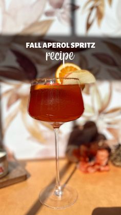 the fall aperoli spritz recipe is garnished with an orange slice