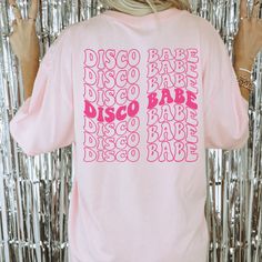 Get ready to turn heads and make memories that last a lifetime with our retro bachelorette party shirts! Whether you're hitting the town for a night of disco fever or channeling your inner cowgirl for a wild west adventure, our bachelorette shirts will have you looking and feeling fabulous. Our cute bridal shirts are designed with comfort and style in mind, so you can dance the night away without a care in the world. So gather your besties and get ready to show the world that you're ready to par Casual Bachelorette Party T-shirt, Trendy Tops For Night Out At Festivals, Pink Tops For Bachelorette Party, Vintage Party Tops With Letter Print, Retro Cotton Party Tops, Vintage Letter Print Tops For Party, Retro Party Tops With Graphic Print, Retro Graphic Print Party Tops, Retro Pink Pre-shrunk Shirt