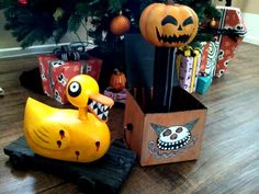 a rubber duck sitting on top of a wooden crate in front of a christmas tree