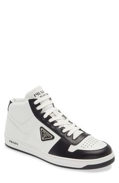 Three different versions of the iconic Prada logo brand this sporty high-top done in two-tone leather and finished with a perforated toe for breathability. Lace-up style Leather upper and lining/rubber sole Made in Italy Men's Designer Shoes Designer High-top Sneakers With Embossed Logo For Streetwear, Luxury High-top Sneakers With Contrast Sole For Streetwear, Luxury High-top Sneakers With Contrast Sole, Luxury High-top Sneakers With Round Toe For Sports, Luxury High-top Sneakers With Logo, Luxury White High-top Sneakers With Embossed Logo, Luxury High-top Sports Sneakers, Sporty High-top Sneakers With Logo Detail, Luxury High-top Sneakers With Embossed Logo