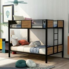 a bunk bed in a room with white walls and wood flooring on the side