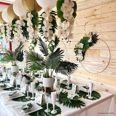 the tables are set with white flowers and greenery