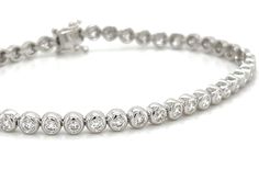 Indulge in ultimate luxury with our stunning 1.82carat diamond bezel set tennis bracelet. With a bezel setting, each diamond is securely held in place, while the tennis style allows for maximum sparkle and shine. Elevate any outfit with this timeless and elegant piece. Metal: 18K White GoldDiamond Weight: 1.82ct twDiamond Shape: 46 Round BrilliantSetting Type: Bezel SetLength: 7 inch / 18cm Necklace Guide, Tennis Style, Diamond Initial Necklace, Jewelry Appraisal, Bridal Engagement Rings, Sparkle And Shine, Eternity Wedding Band, Jewelry Rings Diamond, Jewelry Repair