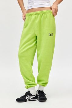 So brat in these sweatpants style topped with a Charlie XCX Brat graphic at the front. Designed in a soft, brushed knit featuring a mid-rise elasticated waistband, relaxed tapered leg and cinched hems. Only at Urban Outfitters. Features Charli XCX Brat graphic jogger sweatpant Graphic lounge pant Soft brushed knit Mid-rise elasticated waistline Brat graphic at the front Relaxed, tapered fit Ankle length Easy pull-on style UO exclusive Content + Care 50% Cotton, 50% polyester Machine wash Imported Size + Fit Model in Green is 5’9" and wearing size Small Measurements taken from size Medium Waist: 28" Inseam: 29" Length: 44" | Charli XCX UO Exclusive Brat Graphic Jogger Sweatpant in Green, Women's at Urban Outfitters Trendy Sports Sweatpants With Elastic Waistband, Baggy Letter Print Joggers For Streetwear, Trendy Sports Sweats With Ribbed Waistband, Green Cotton Sweatpants With Ribbed Waistband, Green Sweatpants With Elastic Waistband For Winter, Trendy Sweatpants With Letter Print For Spring, Green Bottoms With Letter Print For Streetwear, Trendy Cotton Sweats For Jogging, Green Winter Sweatpants With Elastic Waistband