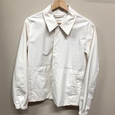 Brand New With Tags, White Nylon Jacket By Helmut Lang And Parley Collaboration. Tonal Snap Buttons, Elasticized Cuffs, Logo Subtly Stamped On Chest And Backside. Suspender Detailing Inside. Chest : 21.3” Length: 28.3” Shoulders: 17.7 Sleeves: 26” Classic White Utility Jacket For Work, Classic Collared Windbreaker For Streetwear, Classic Windbreaker For Spring, Classic White Long Sleeve Utility Jacket, Classic Collared Windbreaker With Pockets, White Windbreaker For Workwear In Winter, White Winter Windbreaker For Work, Classic Collared Windbreaker For Work, Classic Cotton Windbreaker For Work