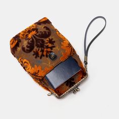 With a nod to the Victorian era, MCW’s freshly combines the classic and elegant design of the traditional carpet bag with a textural and tactile twist.The main body of the functional phone case is made with rich chenille carpet, cotton floral canvas, and brass clasp with double kiss lock. With the width 4.15" and height 8.60" it can easily hold phones of any sizes (max phone width to 4"), with the leather wrist strap that comes with the bag. There are two mini rings at both sides of the clasp and it will come with a 60" detachable chain with hooks so this bag could be switched to crossbody.Both exterior and inside divider are padded with 100% cotton canvas, providing complete protection for the stuffs. This Victorian Carpet Case is designed to hold cell phone, passport, cards, reading glas Vintage Phone Bag With Removable Pouch For Travel, Vintage Travel Phone Bag With Removable Pouch, Vintage Phone Bag With Removable Pouch, Vintage Rectangular Phone Bag With Removable Pouch, Vintage Phone Bag With Cell Phone Pocket For Travel, Vintage Phone Bag For Travel, Vintage Travel Phone Bag With Cell Phone Pocket, Victorian Carpet, Cards Reading