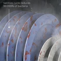 several white and brown plates stacked on top of each other with the words sanitize cycle reduces 99 99 % of bacter