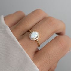 Beautiful opal ring featuring an oval cut with a pavé halo. It is absolutely stunning!  - - - D E T A I L S - - - * Made of 925 Sterling Silver * We use a THICK, DURABLE 14k Gold, Rose Gold, or Rhodium plating - for a piece that will last you years to come! * Lab Created Opal- we use the highest grade for an authentic look * VERY HIGH QUALITY * Nickel-free & Hypoallergenic * Available in sizes 4-10 * Opal Stone w Halo: 10mm  Ring Sizer- https://www.etsy.com/listing/1240904225/ring-sizer-reusable-ring-sizer-plastic?click_key=61e9f4f91cda17e59794f2a68a822a251ab4529d%3A1240904225&click_sum=ffc40ac5&ga_search_query=ring%2Bsizer&ref=shop_items_search_2&pro=1 Made with 100% Pure Love! ♡ Happy to answer any questions you may have! 🥰 Let's Connect! 🥰 IG: samijewels_ Simple Opal Engagement Ring, Classic Opal Ring, Wedding Ring Opal, Senior Rings, Opal Birthstone Ring, Antique Opal Ring, Dainty Opal Ring, Opal Ring Silver, Opal Engagement Rings