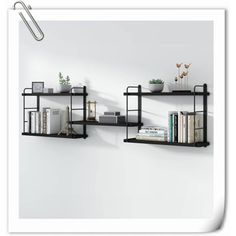 three black shelves with books and plants on them