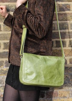 The Denise bag in apple green leather measures 28x20x8cms. The base width is 8cms. It has six compartments in total and the lining is black and waterproof. This bag is reinforced by rivets on the side allowing you to carry a good deal of weight. The multi-compartments make this bag extremely practical for everyday use! The back compartment measures 24cms x 14cms. The internal zip is 17 x 14cms. The main zip is 25cms x 19.5cms. The under flap zip compartment measures 19x15cms. The magnet pocket is 25 x 11cms. The width of the strap is 2.5cms, and the length is 132cms fully adjustable. Modern Green Flap Bag For Everyday, Green Rectangular Shoulder Bag For School, Green Rectangular School Bag, Green Satchel Shoulder Bag For School, Green Satchel Bag For School, Green Rectangular Flap Bag For Travel, Green Crossbody Flap Bag For Travel, Modern Green Flap Shoulder Bag, Modern Green Shoulder Flap Bag