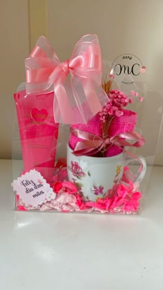 a pink gift box with flowers and a coffee cup