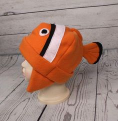 an orange and white clown fish hat on a mannequin head