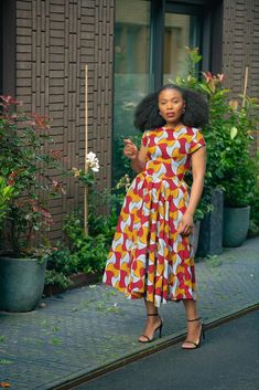 Coming through with strong and vibrant colours is red and yellow Marigold Dress, inspired by the bright and resilient Marigold flowers. With its striking red and yellow hues, this dress embodies the flower's warmth and beauty. Designed for durability and comfort, it's perfect for any occasion. Embrace the positivity and radiance of Marigolds in your attire with this radiating dress. Two side pockets Elastic band at the back.  Lined torso. Dress length is 46 inches for size S to L, 47 inches for Yellow Short Sleeve Dress With Vibrant Print, Vibrant Red Fitted Midi Dress, Vibrant Red Short Sleeve Dress, Fitted Red Midi Dress With Vibrant Print, Vibrant Red Fitted Maxi Dress, Red Fitted Vibrant Maxi Dress, Red Midi Dress With Vibrant Print, Vibrant Yellow Fitted Maxi Dress, Vibrant Fitted Yellow Maxi Dress