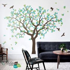 a living room with a tree and birds on the wall