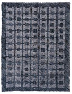 a gray and black rug with squares on the bottom, in different shades of grey