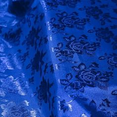 a blue table cloth with floral designs on it