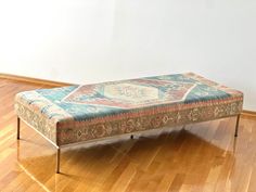 a bench sitting on top of a hard wood floor