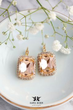 Light Peach Bridal Earrings. These drop earrings, featuring octagon-shaped light peach crystals, are perfect for brides and bridal parties. Their timeless design makes them versatile accessories for weddings, formal events, or everyday wear. They also make a thoughtful and stylish gift for loved ones. Details :  ● Materials- 14k Gold Plated over brass Premium Quality European Crystals. ● Leverback Earrings  ● Size 30mm x 16 mm/1.18 inch x 0.62 inch ● Color Light Peach, Clear White Crystals  ● Eu Blush Pink Earrings, Bridal Dangle Earrings, Blush Pink Bridesmaids, Pink Drop Earrings, Rose Gold Drop Earrings, Morganite Earrings, Blush Earrings, Peach Earrings, Wedding Earring