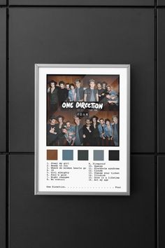 a poster hanging on the wall next to a black tiled wall with an image of one direction