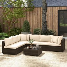 a couch and table in a backyard setting