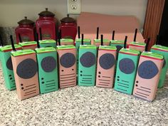 six old fashioned radio boxes are lined up on the counter