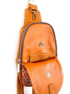 Handcrafted with quality full-grain leather, this crossbody sling bag features a zip-top closure and an interior pocket to keep your everyday essentials secure yet accessible and a small coin purse attached. This bag can be worn across the body (sling) or as a mini backpack. The interior of the bag is lined with beautiful, newly handwoven artisan fabric. Artisan embroidered up-cycle fabric in the outside, making every bag unique. Every bay is one-of-a-kind and slow-crafted by leather artisans in Leather Chest Bag With Zipper Closure For On-the-go, Brown Saddle Bag With Adjustable Strap For Everyday, Brown Crossbody Chest Bag For Business, Business Brown Crossbody Chest Bag, Brown Pouch Chest Bag With Zipper, Brown Pouch Chest Bag With Zipper Closure, Leather Pouch Chest Bag For Travel, Brown Chest Bag With Zipper Pocket For Daily Use, Brown Zipper Closure Pouch Chest Bag