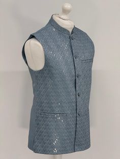 Introducing our exquisite Men's Jamawar Waistcoat, a luxurious addition to any gentleman's wardrobe. Handcrafted from the finest quality Jamawar fabric, this waistcoat is fully lined for added comfort. Featuring a timeless design, it comes with silver and black buttons that add a touch of elegance to any outfit. The waistcoat also comes with pockets, providing ample storage space for your essentials. Perfect for formal occasions, this waistcoat is sure to make a statement and impress all those a Fitted Sleeveless Nehru Jacket For Winter, Festive Formal Fitted Vest, Elegant Sleeveless Nehru Jacket For Festive Occasion, Sleeveless Nehru Jacket For Formal Festive Occasions, Festive Sleeveless Nehru Jacket For Formal Occasions, Fitted Sleeveless Outerwear For Festive Occasions, Elegant Sleeveless Nehru Jacket For Formal Occasions, Elegant Sleeveless Festive Outerwear, Gentleman's Wardrobe