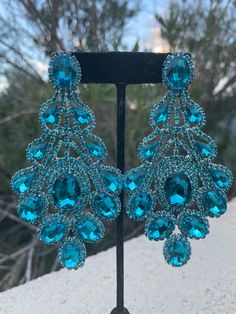 Turquoise Earrings For Evening, Blue Crystal Chandelier Earrings For Party, Light Blue Drop Earrings For Party, Blue Rhinestone Earrings For Evening, Light Blue Dangle Crystal Earrings For Party, Turquoise Crystal Jewelry For Party, Blue Jeweled Crystal Earrings, Party Turquoise Crystal Jewelry, Turquoise Chandelier Earrings For Party