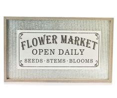 a sign that says flower market open daily seeds stems bloom's on the side