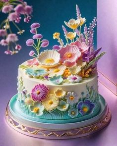 a multi - layer cake decorated with flowers on a plate next to a purple wall