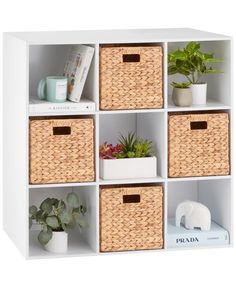 a white shelf filled with baskets and plants