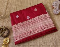 A fabulous and regal saree in Pure Silk. Thus here we bring  to you a Deep Red Banarasi Handloom Katan Silk Konia Saree. Moreover the fabric is pure silk/pattu and the work is in fine golden and silver zari. Thus we would say a not to be missed collection. About Banarasi Weaves A heirloom of Banaras - Katan Silk Saree. These are handloom sarees which takes 2-3 weavers and more than a month to weave a single saree. Furthermore the motifs are inspired my the Mughal era. Additional Information Color : Red/Maroon Technique: Banarasi Kadhuwa Sona Rupa Weaving Fabric: Pure Katan Silk Blouse Piece: Included Traditional Wear Saree For Eid Rituals, Katan Silk Dupatta With Zari Work For Rituals, Bollywood Art Silk Blouse Piece For Rituals, Banarasi Silk Saree For Navratri Rituals, Katan Silk Saree With Dupatta For Rituals, Bollywood Style Art Silk Blouse For Rituals, Chanderi Saree For Eid Rituals, Katan Silk Saree For Diwali Rituals, Bollywood Style Raw Silk Saree For Rituals