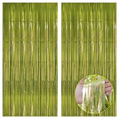 a hand holding a glass in front of a green curtain with the image of a bamboo tree