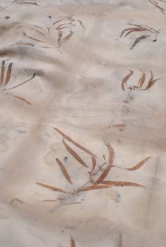 the sand is covered with brown and white designs on it's surface, as if in nature