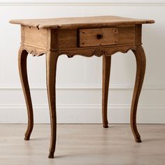 an old wooden table with two drawers on one side and a drawer on the other