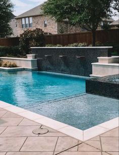 an empty swimming pool in the middle of a backyard